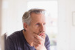 © Sam Edwards/Caia Image - Mature man touching face in bathroom mirror