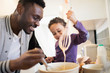 © Sam Edwards/Caia Image - Father and toddler son baking in kitchen