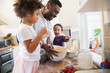 © Sam Edwards/Caia Image - Father and toddler children baking in kitchen