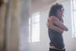 © Sam Edwards/Caia Image - Focused, dedicated young female dancer stretching in dance studio