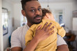 © Sam Edwards/Caia Image - Portrait affectionate father holding tired baby son
