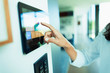© Paul Bradbury/Caia Image - Close up woman at home automation touch screen panel