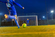 © Paul Bradbury/Caia Image - Girl soccer player kicking ball toward goal