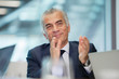 © Robert Daly/Caia Image - Smiling, confident senior businessman clapping in meeting