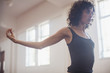 © Sam Edwards/Caia Image - Focused, determined young female dancer stretching in dance studio
