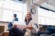 © Sam Edwards/Caia Image - Happy, confident businesswoman with paperwork in office