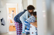© Sam Edwards/Caia Image - Father and children in pajamas at kitchen counter