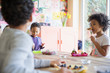 © Sam Edwards/Caia Image - Toddler brother and sister eating breakfast at dining table