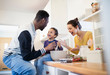 © Sam Edwards/Caia Image - Parents and toddler son baking in kitchen