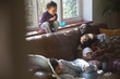 © Sam Edwards/Caia Image - Happy father and children cuddling on living room sofa