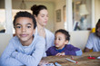 © Sam Edwards/Caia Image - Portrait confident boy coloring with family at table
