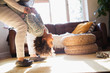 © Sam Edwards/Caia Image - Mother holding daughter upside-down in living room