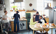 © Tom Merton/Caia Image - Young adult roommate friends enjoying breakfast in apartment kitchen