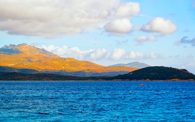  Landscape with Romantic morning at Capriccioli Beach in Costa Smeralda of the Mediterranean sea on Sardinia island in Italy. Sky with clouds. Porto Cervo and Olbia province. Mixed media.