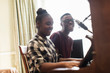 © Sam Edwards/Caia Image - Teenage brother and sister playing piano and singing