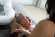 © Sam Edwards/Caia Image - Mother holding crying newborn baby son