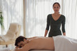 © Tom Merton/Caia Image - Portrait confident female masseuse giving man massage
