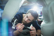 © Tom Merton/Caia Image - Focused male engineer with screwdriver fixing robotic arm