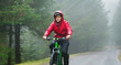 © Robert Daly/Caia Image - Man mountain biking in rain