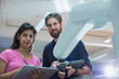 © Tom Merton/Caia Image - Portrait confident engineers with digital tablet programming robotic arm in office