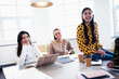 © Sam Edwards/Caia Image - Businesswomen laughing in conference room meeting