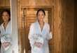 © Tom Merton/Caia Image - Portrait young woman in bathrobe standing in spa doorway