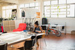 © Tom Merton/Caia Image - Creative businesswoman working in open plan office