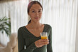 © Tom Merton/Caia Image - Portrait confident young woman drinking orange juice