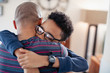 © Sam Edwards/Caia Image - Affectionate son hugging father