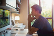 © Tom Merton/Caia Image - Thoughtful man working at computer in home office