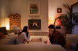 © Tom Merton/Caia Image - Couple playing chess in living room