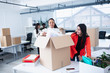 © Sam Edwards/Caia Image - Businesswomen unpacking, moving into new office