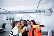 © Sam Edwards/Caia Image - Businesswomen celebrating new office, taking selfie