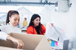 © Sam Edwards/Caia Image - Businesswomen unpacking new office