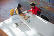 © Tom Merton/Caia Image - Creative businesswomen talking, using digital tablet, planning in conference room meeting