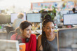 © Tom Merton/Caia Image - Businesswomen meeting, working at computer in office