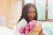 © Tom Merton/Caia Image - Portrait beautiful young woman with bouquet of pink peony flowers