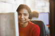© Tom Merton/Caia Image - Portrait smiling, confident businesswoman with headset working at computer in office