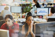 © Tom Merton/Caia Image - Serious businesswomen working at computers in office