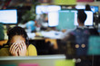 © Tom Merton/Caia Image - Tired, stressed businesswoman with head in hands at computer in office