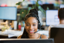 Portrait Confident Businesswoman With Headset At Computer In Office