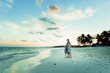 © Paul Bradbury/Caia Image - Family relaxing on tranquil tropical ocean beach Mexico