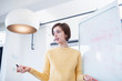 © Sam Edwards/Caia Image - Businesswoman at whiteboard leading meeting