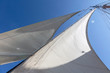 © Martin Barraud/Caia Image - Sailboat sails blowing in breeze below sunny blue sky