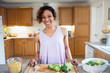 © Sam Edwards/Caia Image - Portrait smiling, confident woman cooking in kitchen