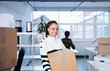 © Sam Edwards/Caia Image - Portrait confident, happy businesswoman moving into new office