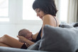 © Sam Edwards/Caia Image - Mother breastfeeding newborn baby on sofa