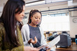 © Sam Edwards/Caia Image - Businesswomen discussing paperwork in office