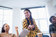© Sam Edwards/Caia Image - Happy businesswoman talking in conference room meeting