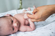 © Sam Edwards/Caia Image - Close up mother holding hands with newborn baby son
